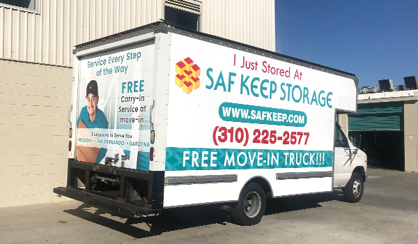 moving truck parked next to drive-up storage unit doors