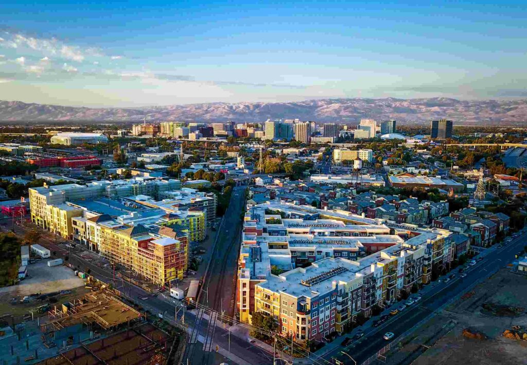 An aerial photograph of downtown San Jose at sunset.