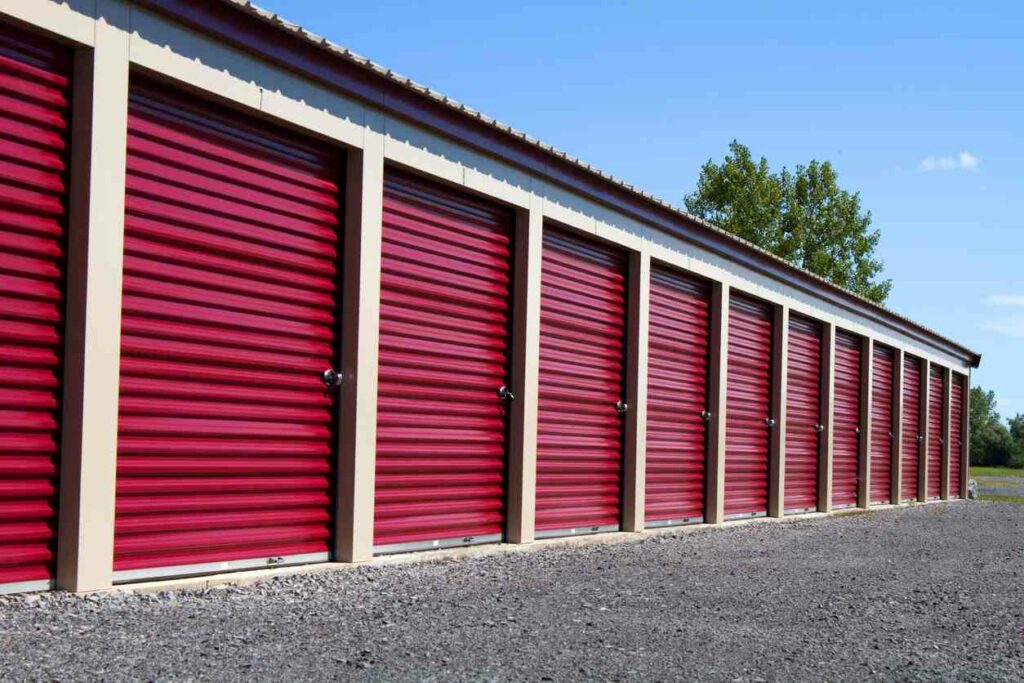 Row of drive-up, non climate-controlled storage units on a sunny day.