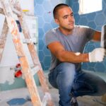 A man renovating his bathroom.