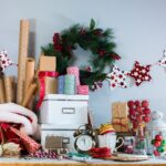 Shot of holiday decorations and packing supplies piled together in a home.