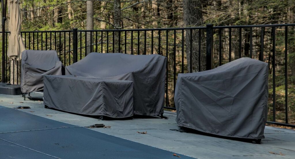 Outdoor chairs and love seats covered for protection from moisture.